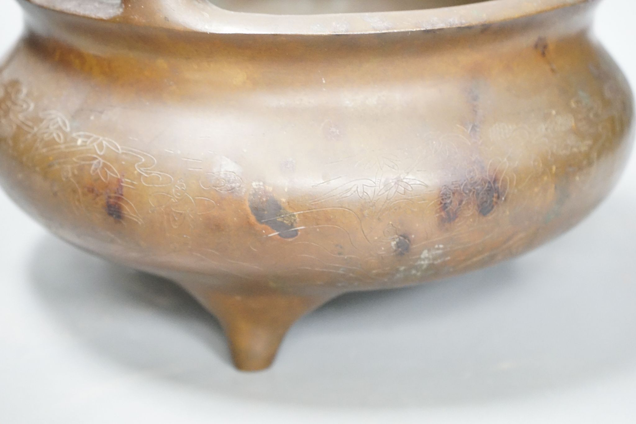 A large Chinese bronze tripod censer, Xuande mark, 24cm handle to handle